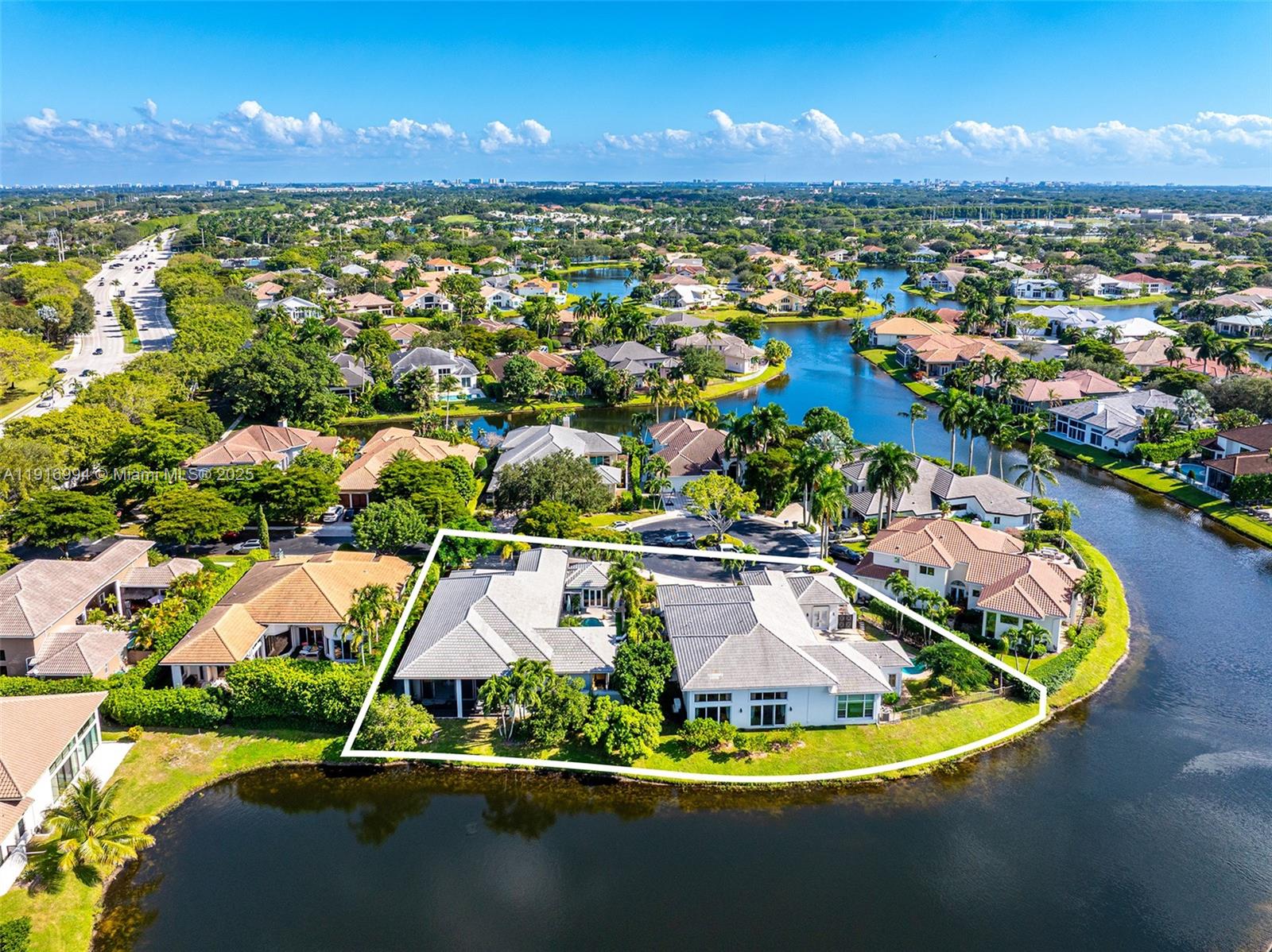 6451 Northwest 32nd Way Boca Raton, FL 33496 - Photo 6 of 54 a view of a swimming pool with lawn chairs under an umbrella