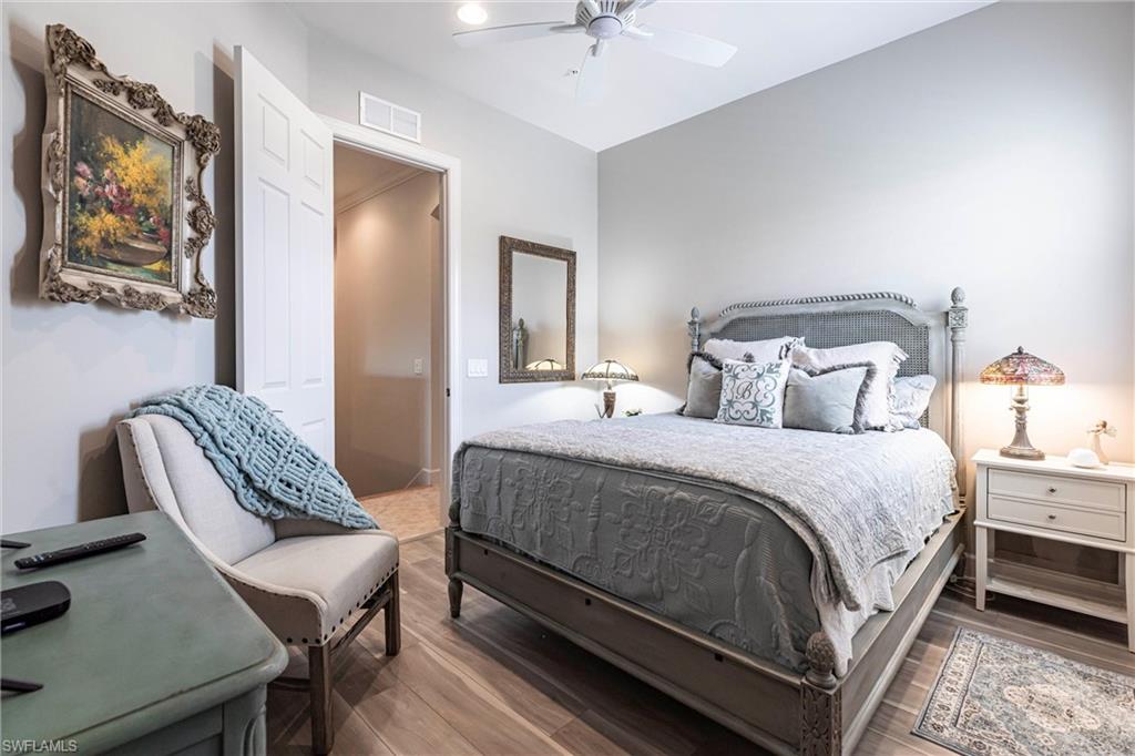 9550 Ironstone Terrace, Unit 201 Naples, FL 34120 - Photo 32 of 50 Bedroom featuring wood finished floors and ceiling fan