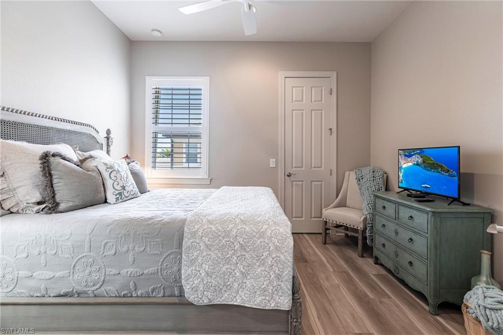 9550 Ironstone Terrace, Unit 201 Naples, FL 34120 - Photo 33 of 50 Bedroom with wood finished floors and a ceiling fan