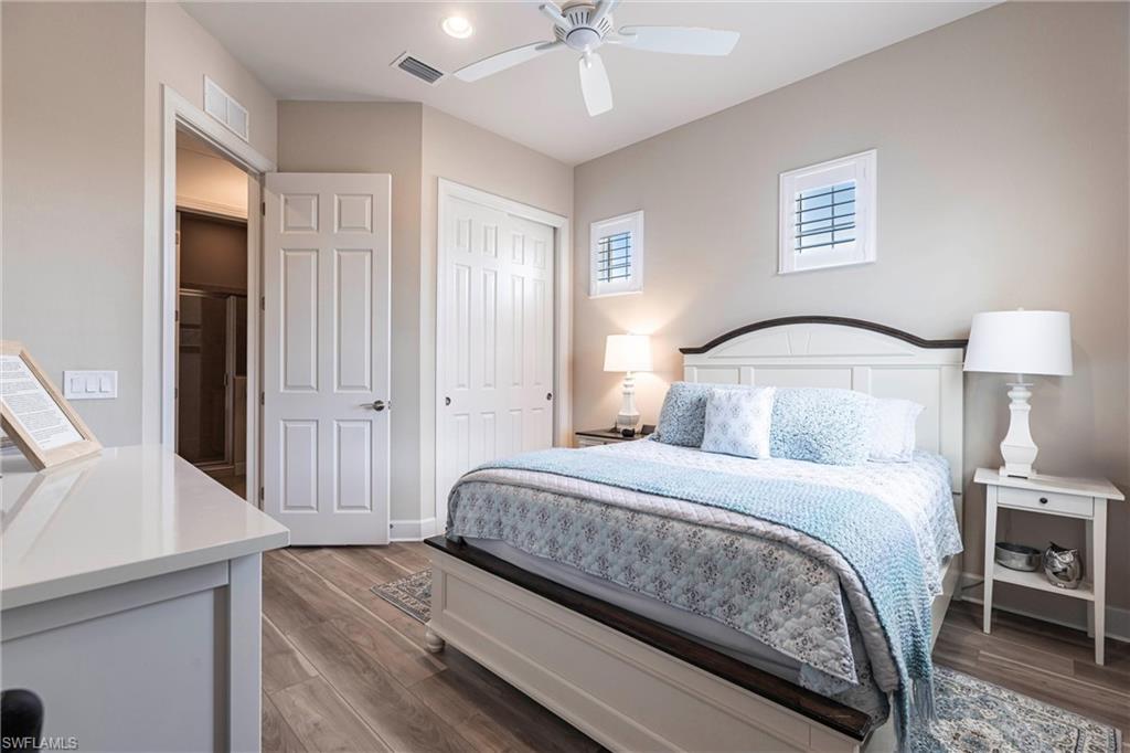 9550 Ironstone Terrace, Unit 201 Naples, FL 34120 - Photo 35 of 50 Bedroom with a closet, wood finished floors, and a ceiling fan