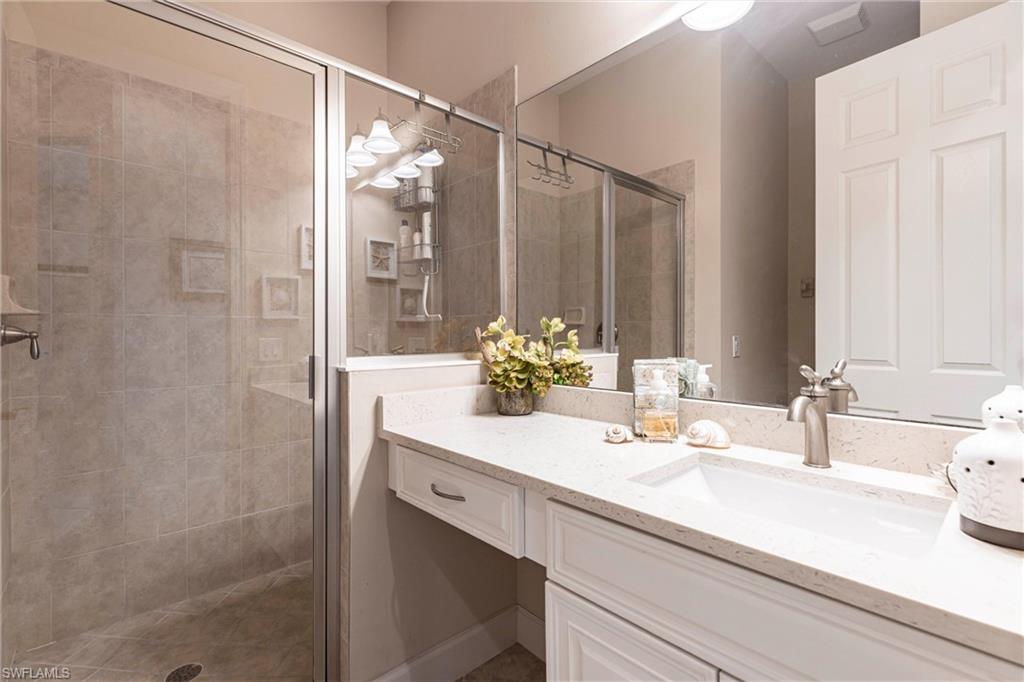 9550 Ironstone Terrace, Unit 201 Naples, FL 34120 - Photo 36 of 50 Bathroom featuring a shower stall and vanity