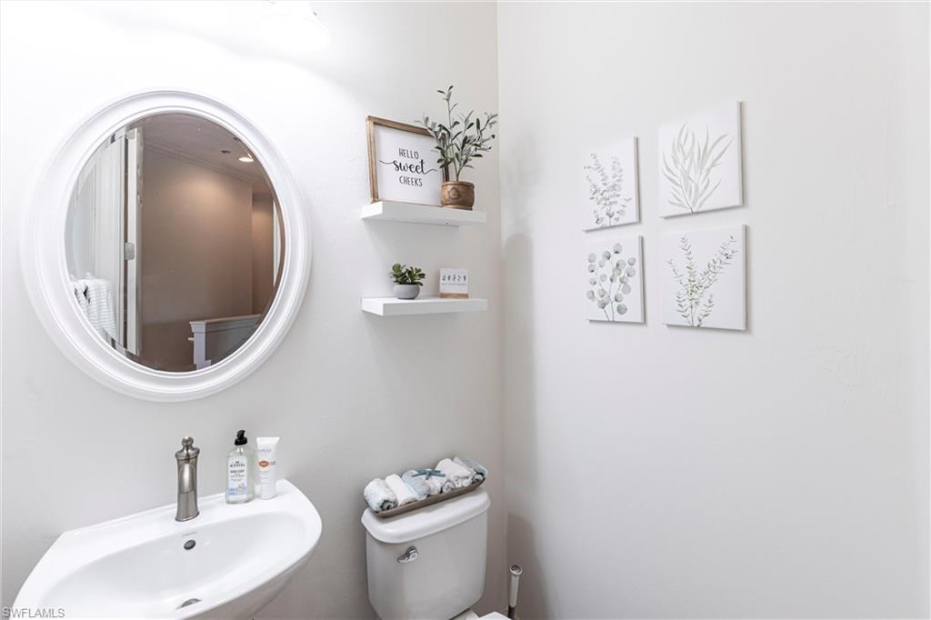 9550 Ironstone Terrace, Unit 201 Naples, FL 34120 - Photo 38 of 50 Half bathroom featuring a sink and toilet