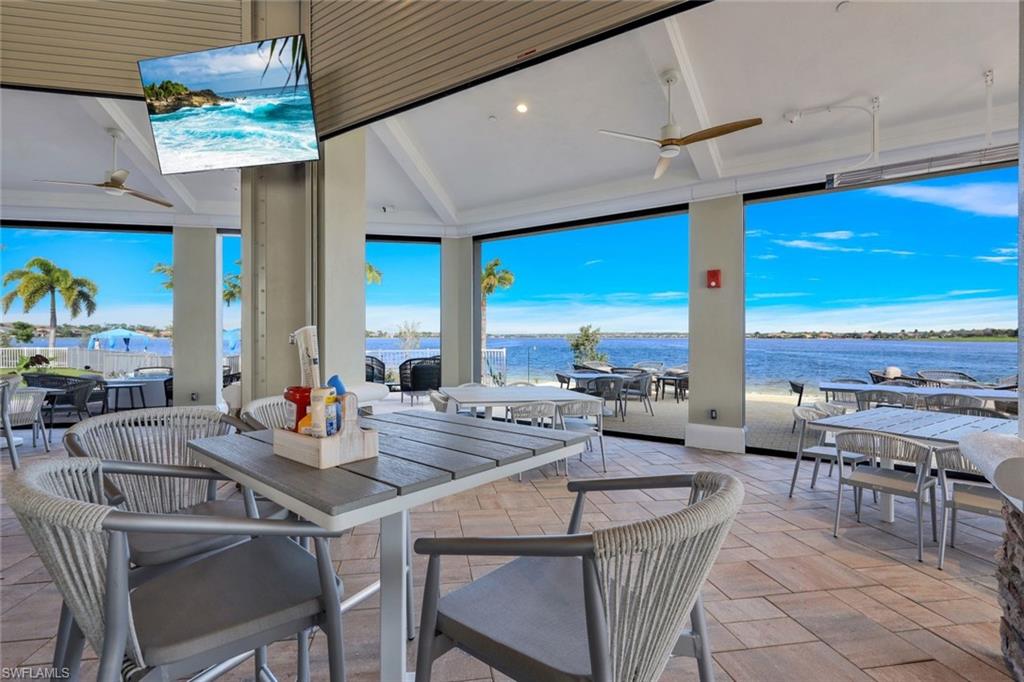 9550 Ironstone Terrace, Unit 201 Naples, FL 34120 - Photo 46 of 50 View of patio with outdoor dining space, a water view, and ceiling fan