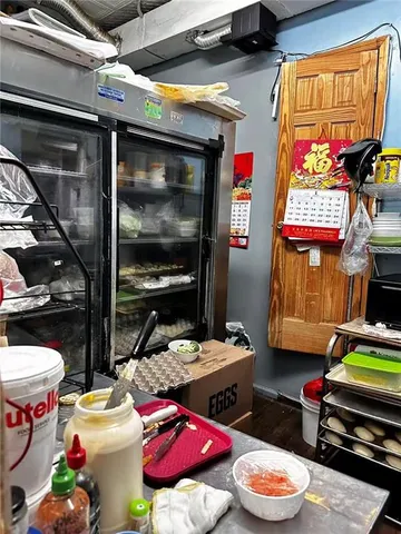a view of a hallway with wooden floor and closet
