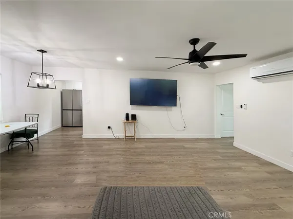 a view of an empty room with a ceiling fan