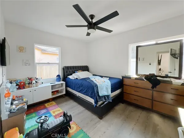 a bedroom with a bed and a couch