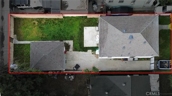 an aerial view of a house with a yard