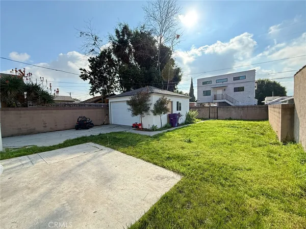 a backyard of a house with table and chairs