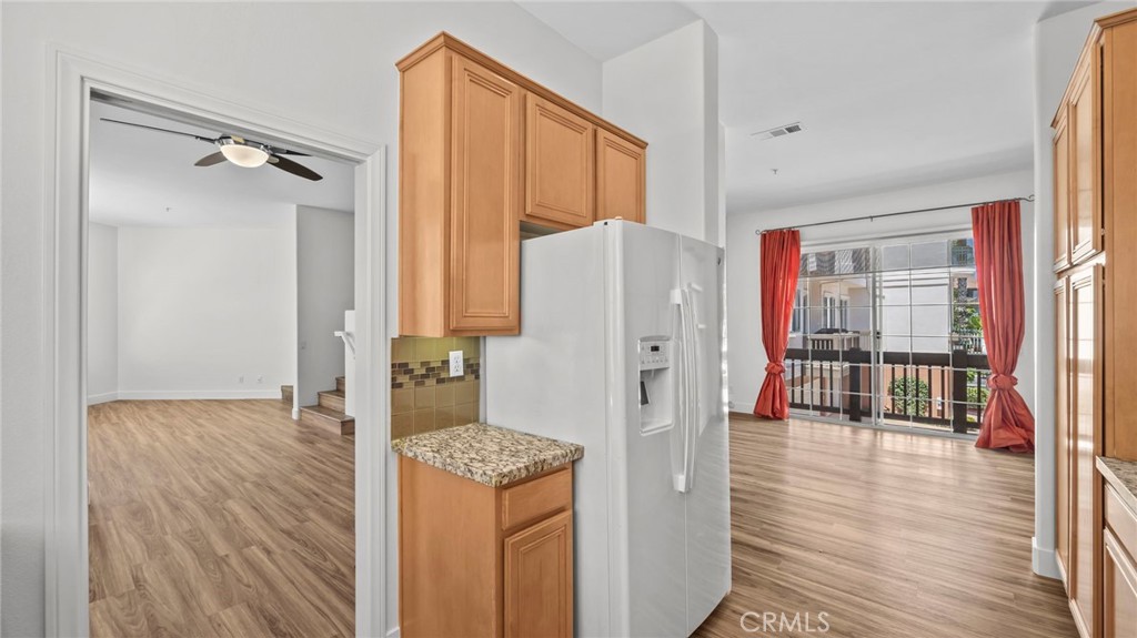 12626 Nicklaus Lane Tustin, CA 92782 - Photo 11 of 36 a walk in closet with wooden floor and a bathroom