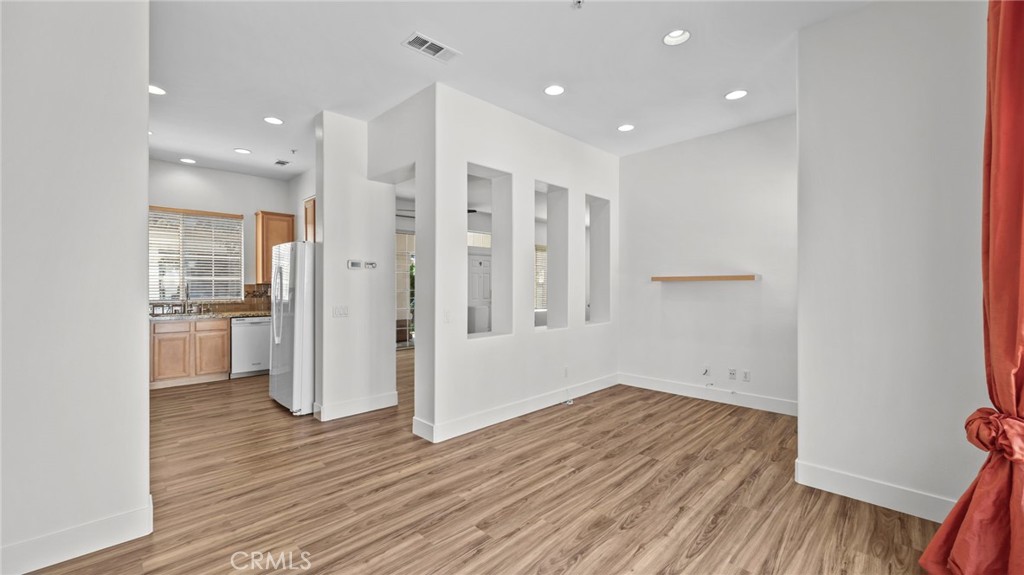 12626 Nicklaus Lane Tustin, CA 92782 - Photo 15 of 36 a view of a kitchen with a refrigerator and wooden floor