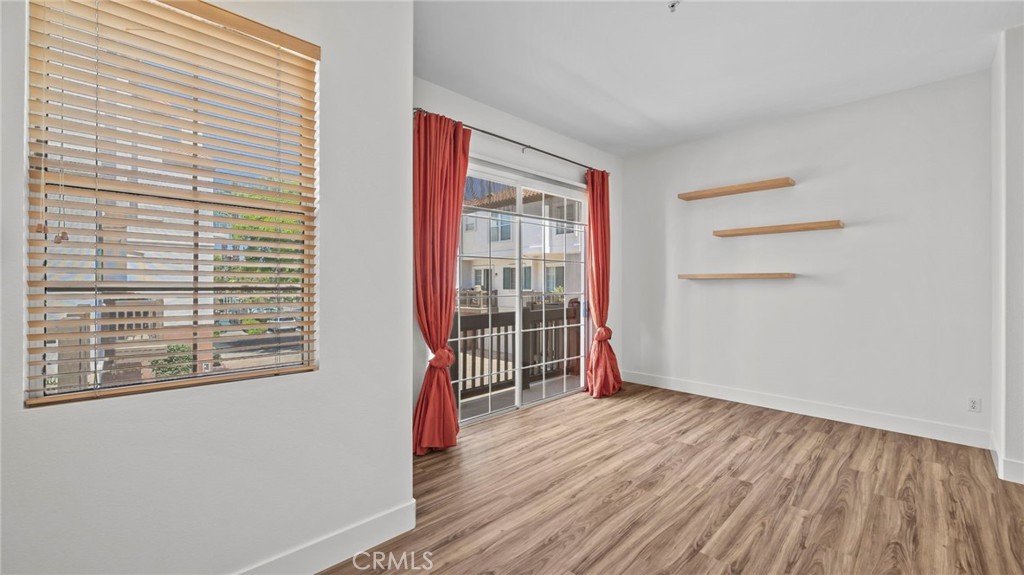 12626 Nicklaus Lane Tustin, CA 92782 - Photo 16 of 36 a view of an empty room with wooden floor and a window