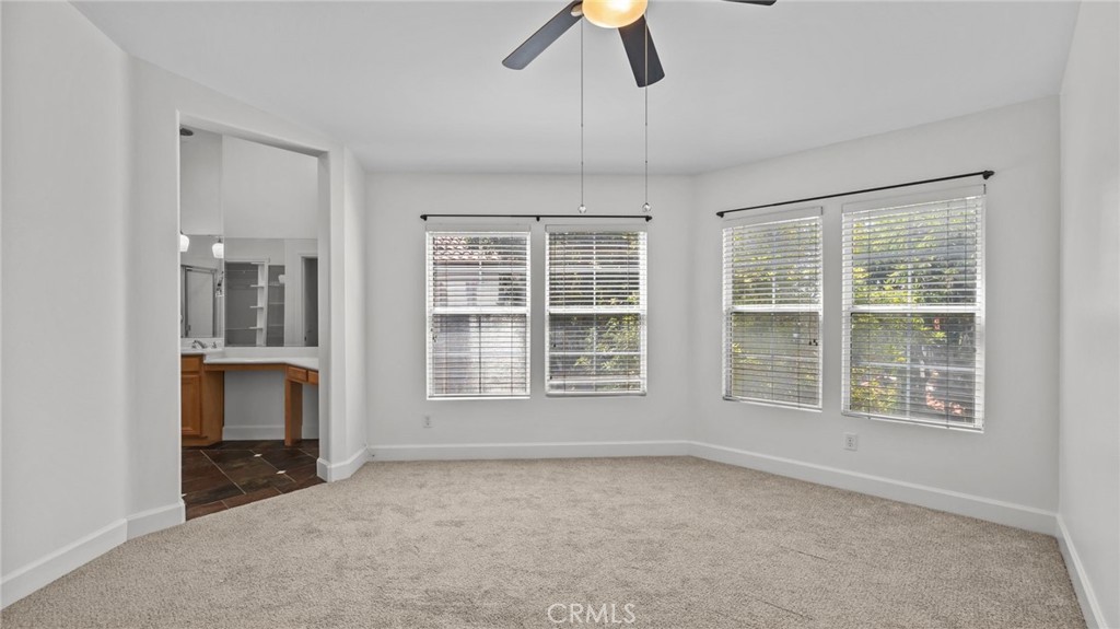 12626 Nicklaus Lane Tustin, CA 92782 - Photo 19 of 36 an empty room with fireplace and windows