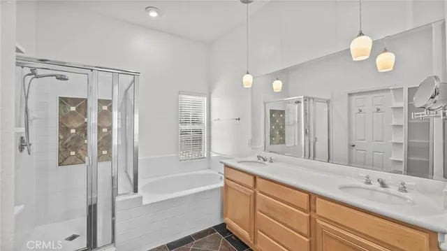 a spacious bathroom with a shower sink and mirror
