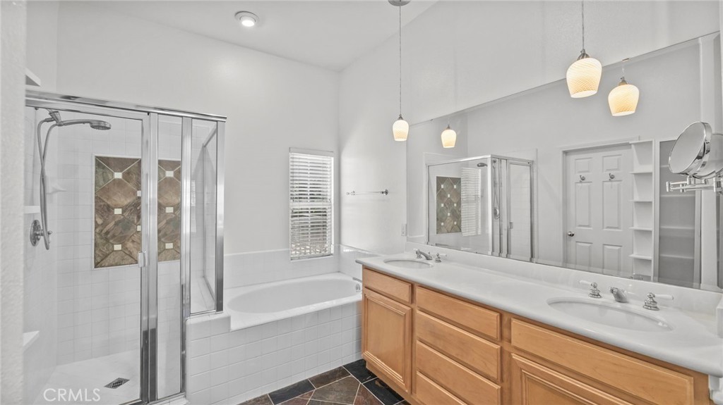 12626 Nicklaus Lane Tustin, CA 92782 - Photo 21 of 36 a spacious bathroom with a shower sink and mirror