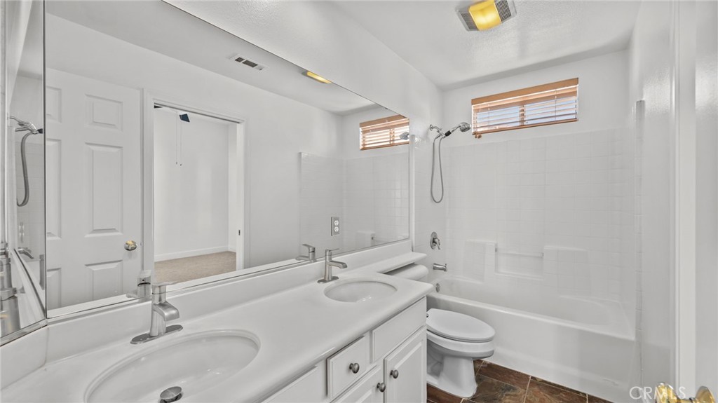 12626 Nicklaus Lane Tustin, CA 92782 - Photo 25 of 36 a bathroom with a sink a toilet and shower
