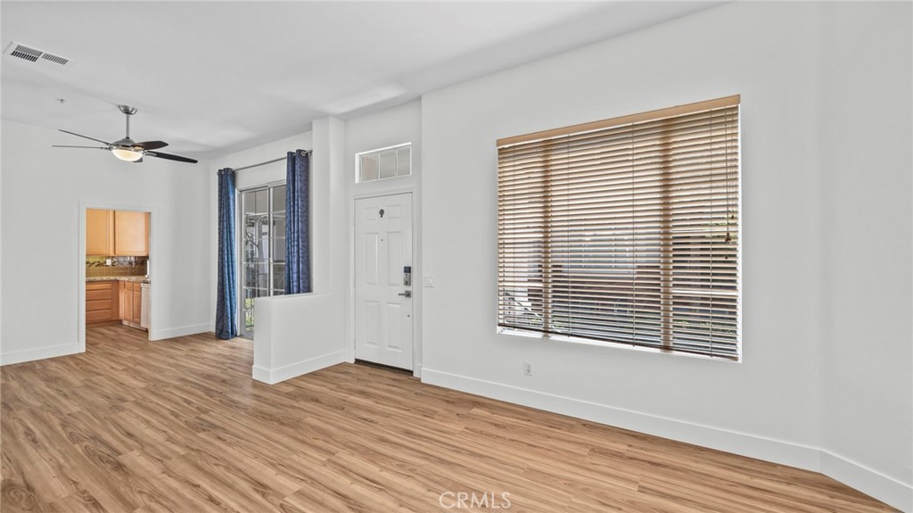 12626 Nicklaus Lane Tustin, CA 92782 - Photo 3 of 36 a view of an empty room with wooden floor and a window