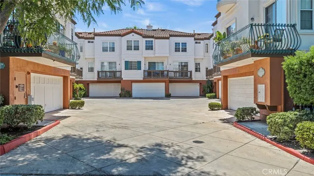 front view of a house with a yard and palm trees