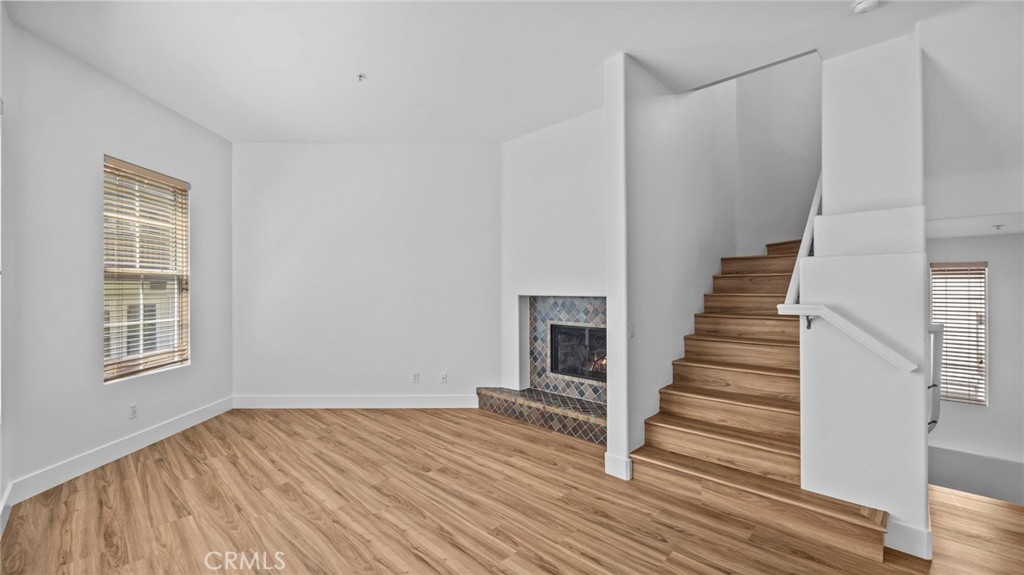 12626 Nicklaus Lane Tustin, CA 92782 - Photo 4 of 36 a view of a room with wooden floor and white walls