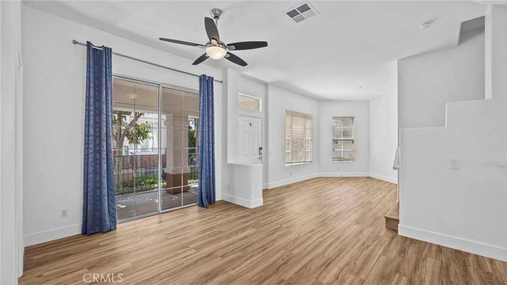 12626 Nicklaus Lane Tustin, CA 92782 - Photo 6 of 36 a view of empty room with wooden floor and fan