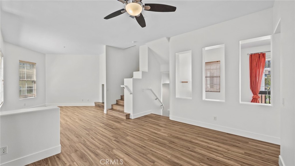 12626 Nicklaus Lane Tustin, CA 92782 - Photo 8 of 36 a view of empty room with wooden floor and window