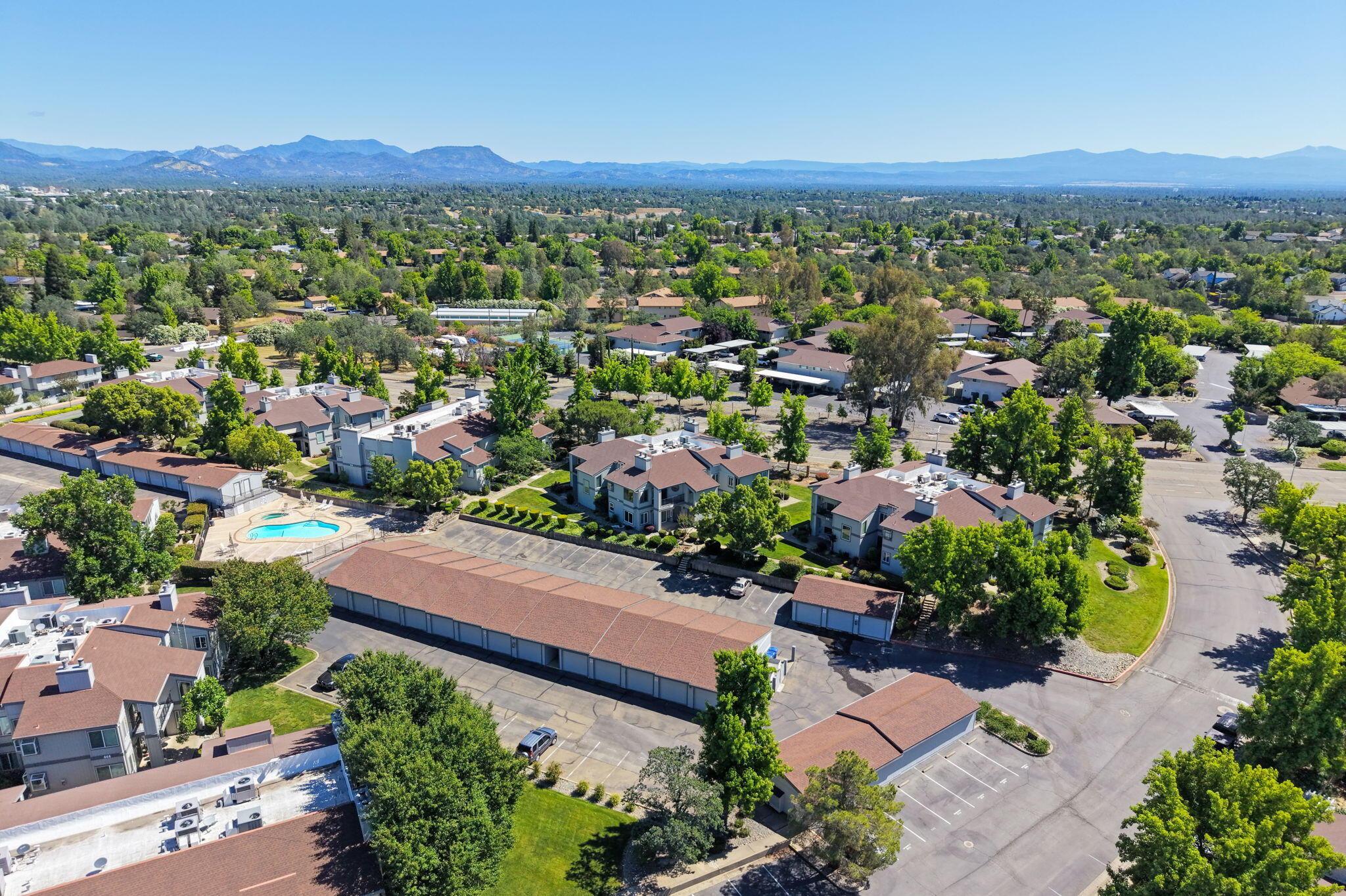 426 Ridgecrest Trail, Unit 223 Redding, CA 96003 - Photo 45 of 59 an aerial view of a city with lots of residential buildings and mountain view in back