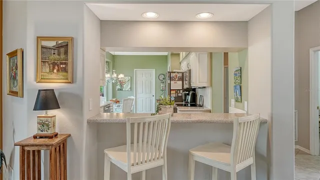 a bedroom with a bed and painting on the wall