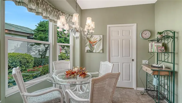 a living room with lots of furniture and view of kitchen