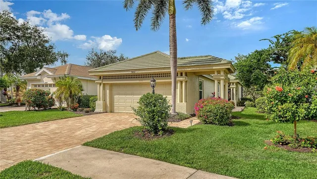a dining room with furniture a chandelier and window