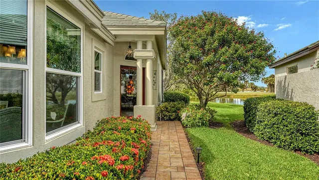 a kitchen with white cabinets and sink