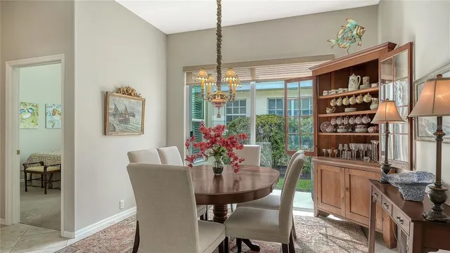 a bedroom with a bed and a dresser next to a window