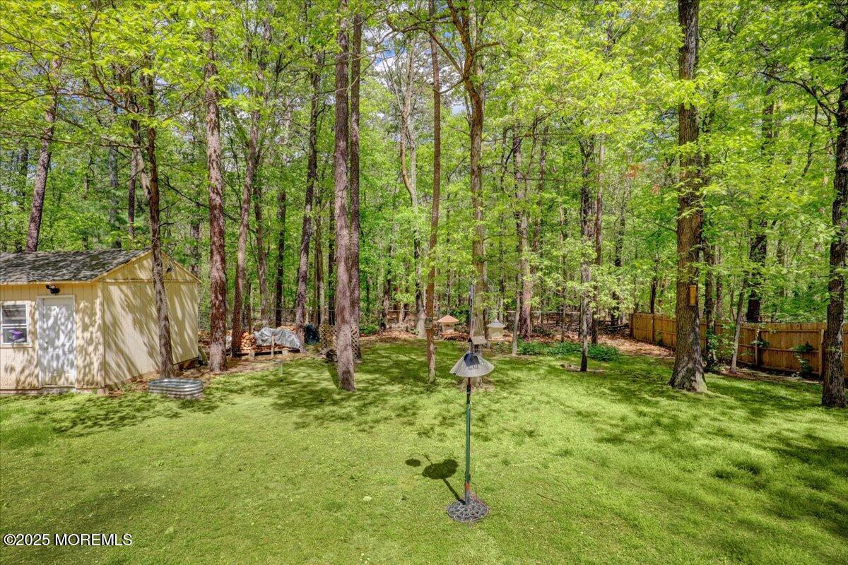 165 Cassville Road Jackson, NJ 08527 - Photo 22 of 24 a backyard of a house with lots of green space and garden