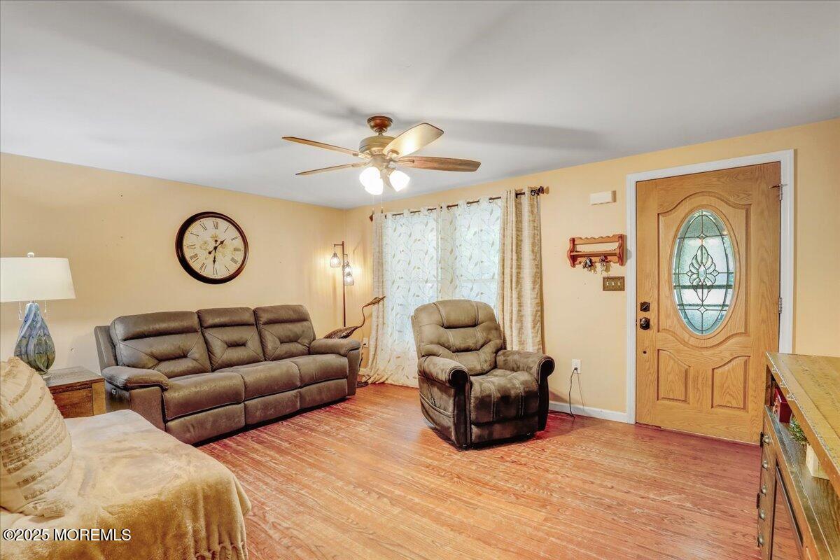 165 Cassville Road Jackson, NJ 08527 - Photo 3 of 24 a living room with furniture a clock and a window