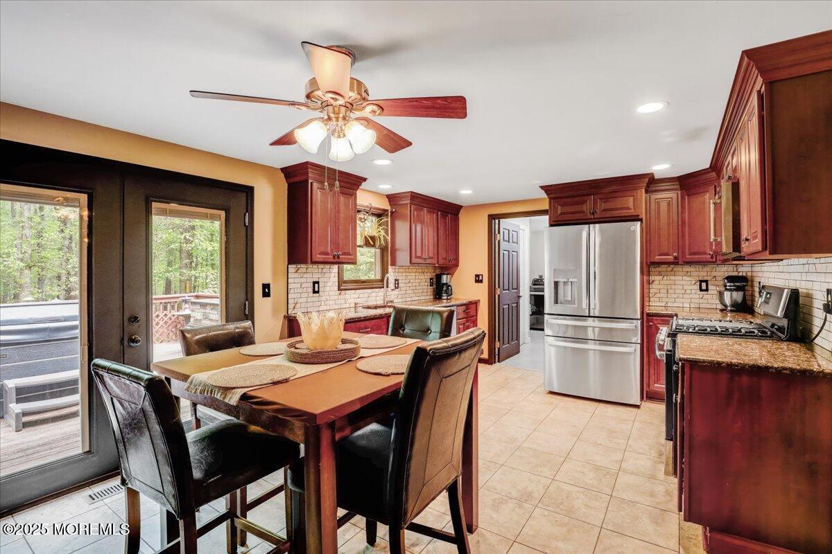 165 Cassville Road Jackson, NJ 08527 - Photo 6 of 24 a kitchen with a dining table chairs stainless steel appliances cabinets and furniture