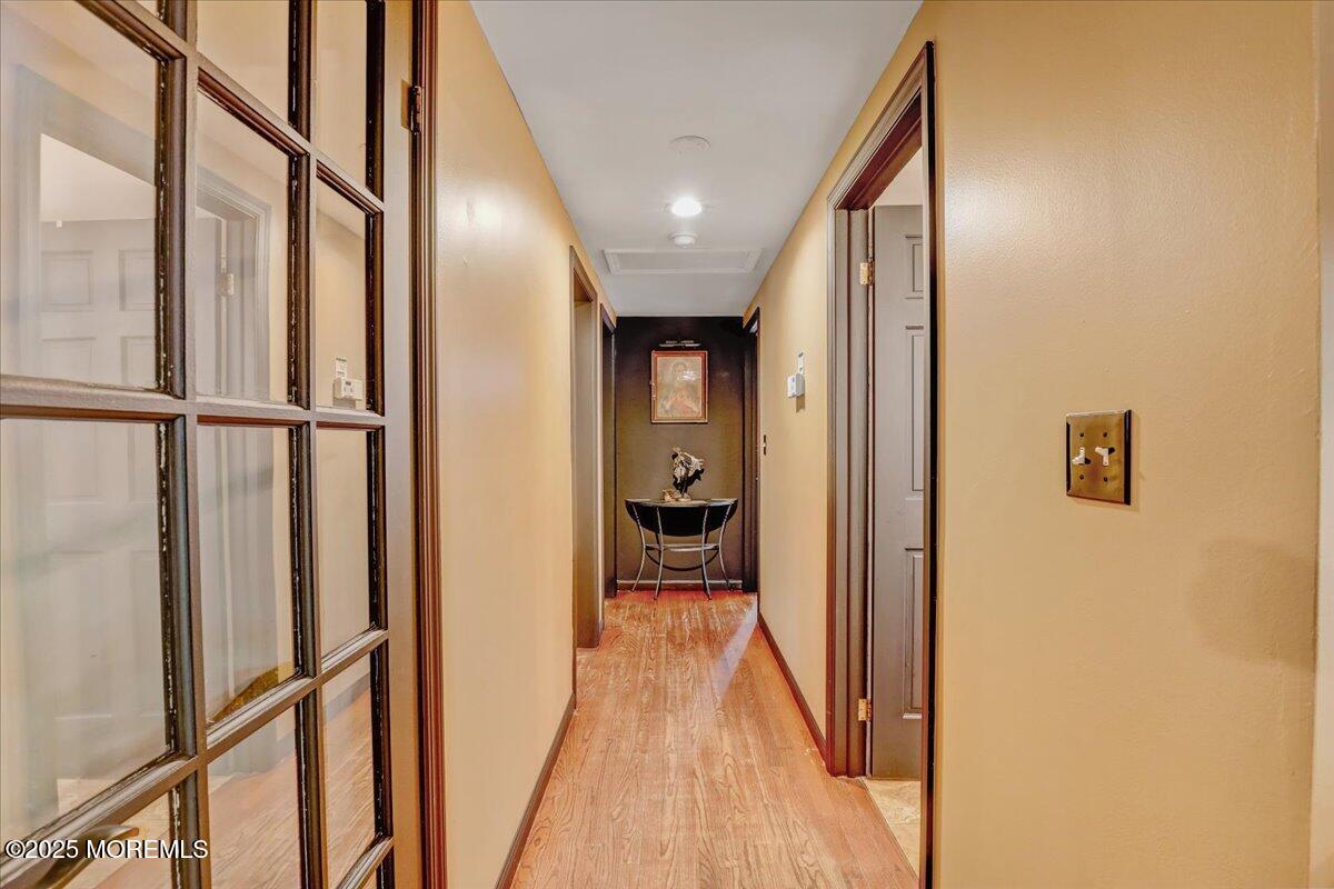 165 Cassville Road Jackson, NJ 08527 - Photo 9 of 24 a view of a hallway with wooden floor and staircase
