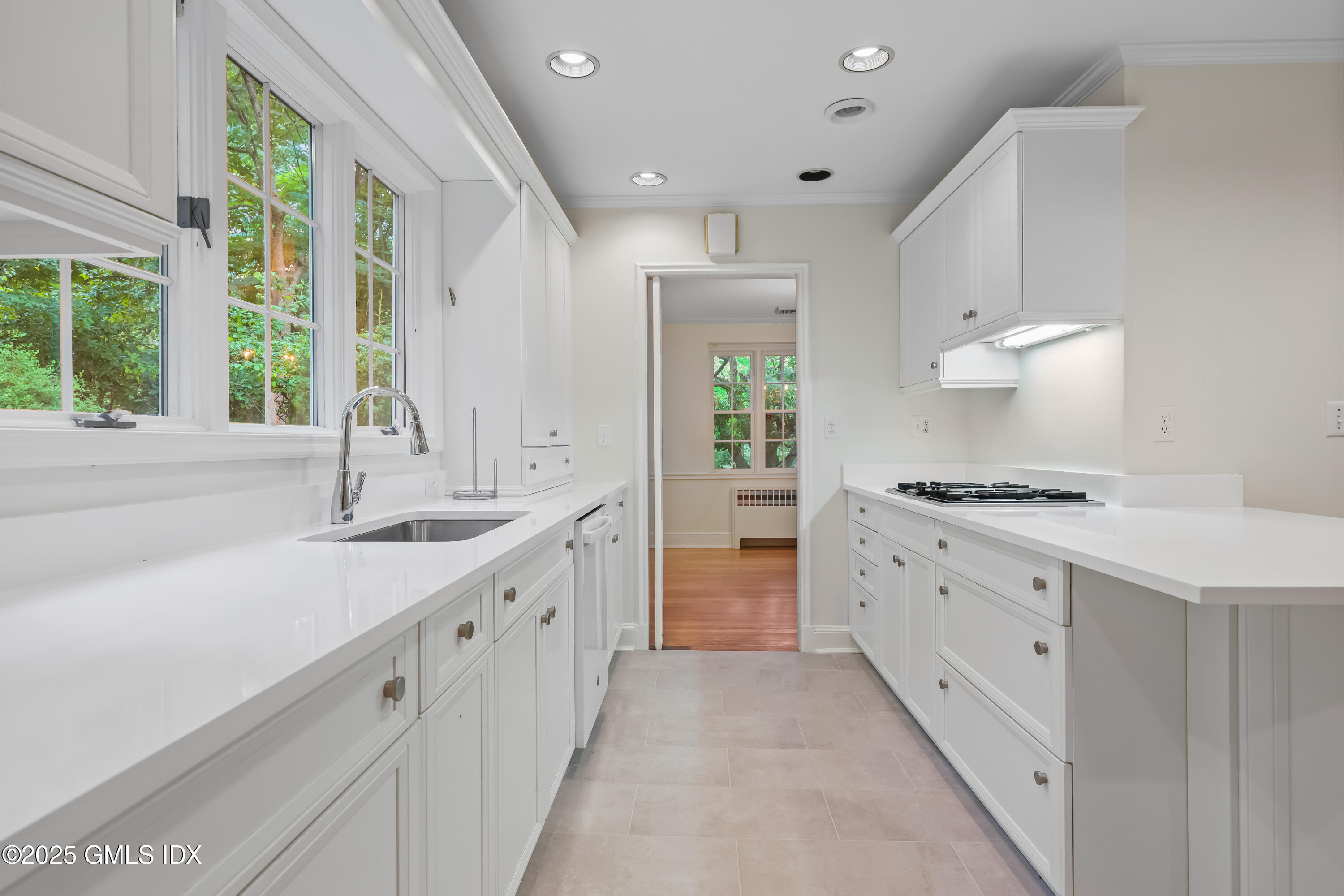 320 Cognewaugh Road Cos Cob, CT 06807 - Photo 11 of 27 a kitchen with granite countertop a sink stove and cabinets