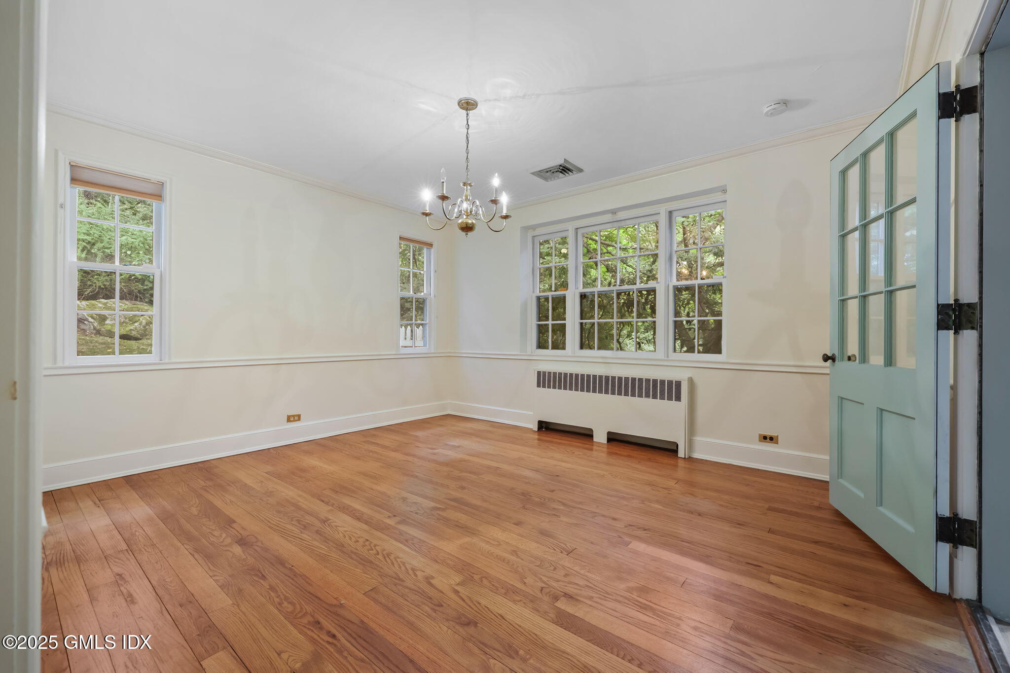 320 Cognewaugh Road Cos Cob, CT 06807 - Photo 15 of 27 a view of an empty room with a window and wooden floor