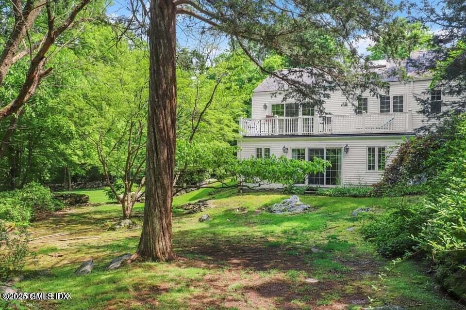 320 Cognewaugh Road Cos Cob, CT 06807 - Photo 2 of 27 a view of a house with a yard and plants