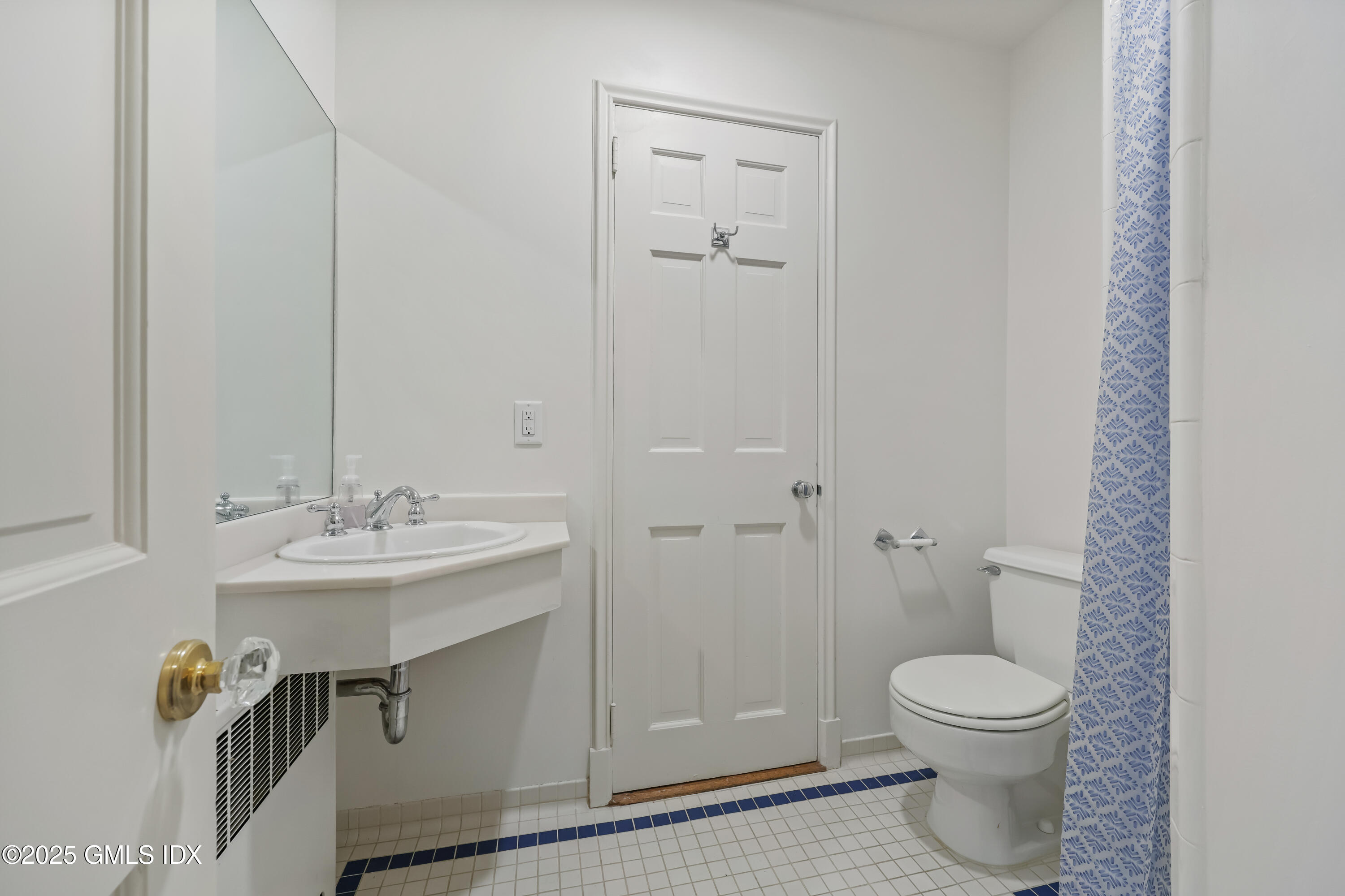 320 Cognewaugh Road Cos Cob, CT 06807 - Photo 21 of 27 a bathroom with a toilet a sink and mirror