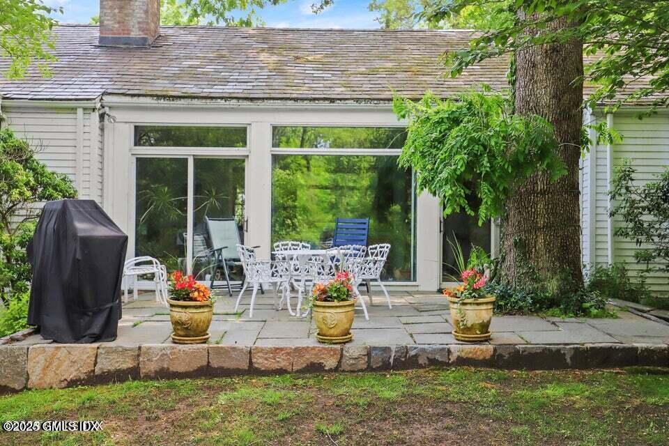 320 Cognewaugh Road Cos Cob, CT 06807 - Photo 5 of 27 a view of a house with backyard sitting area and garden