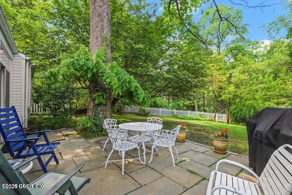 320 Cognewaugh Road Cos Cob, CT 06807 - Photo 6 of 27 a view of a chairs and table in patio with a yard