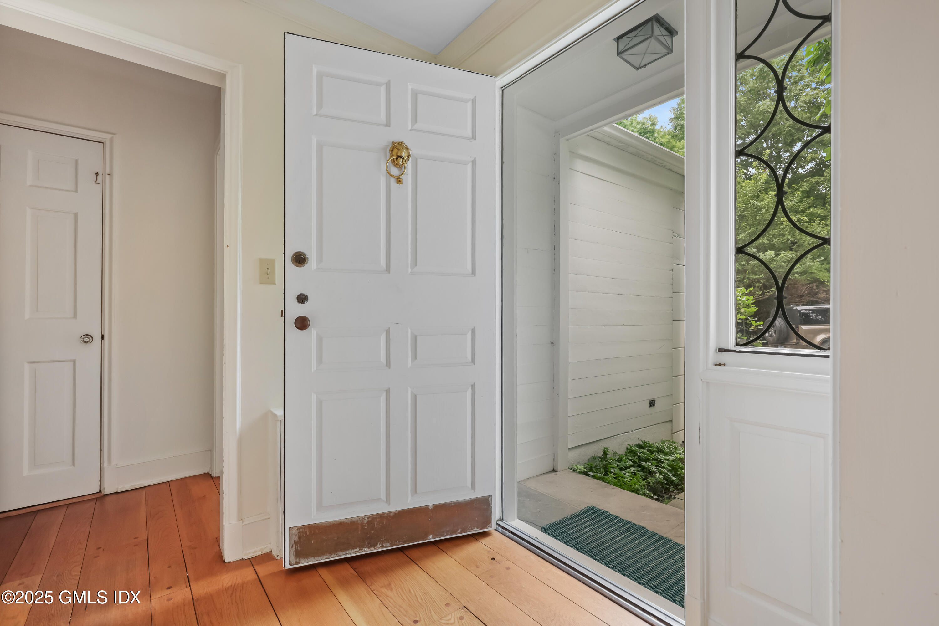 320 Cognewaugh Road Cos Cob, CT 06807 - Photo 8 of 27 a view of a hallway with wooden floor and front door