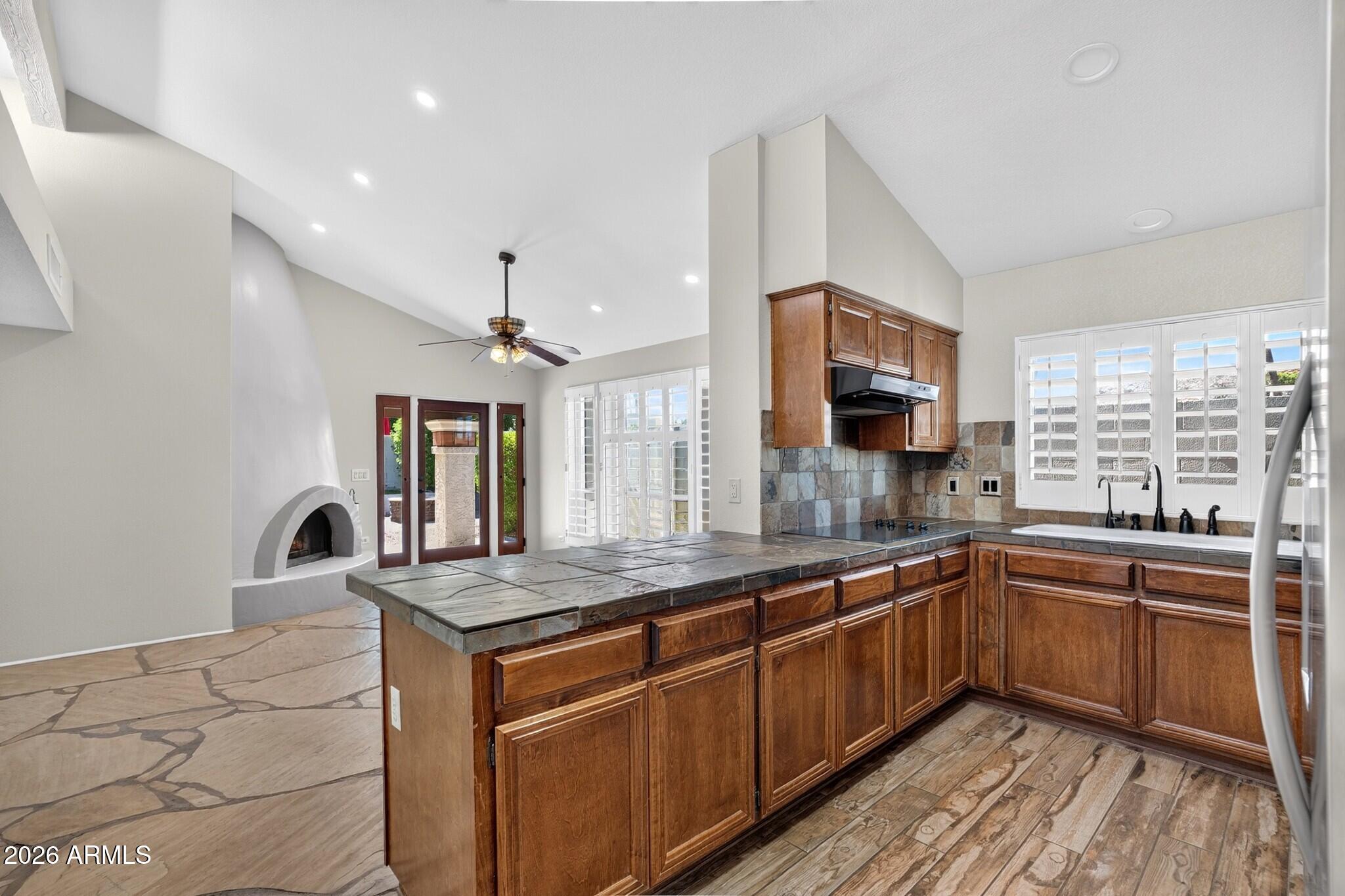 4615 East Monte Way Phoenix, AZ 85044 - Photo 8 of 35 a kitchen with granite countertop sink stainless steel appliances and window