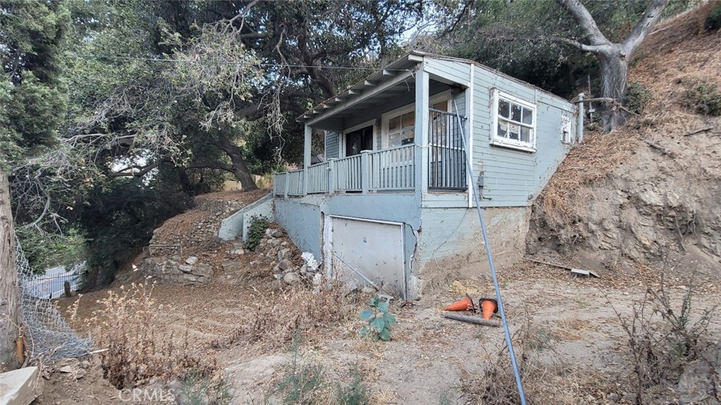 12047 Kagel Canyon Road Sylmar, CA 91342 - Photo 7 of 14 a front view of a house with a yard