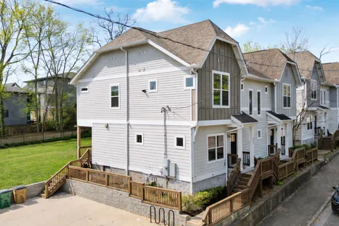 a view of a big house with a yard