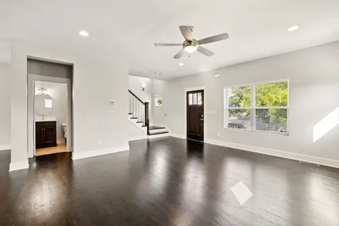 wooden floor in an empty room with a window