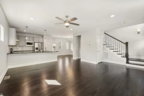 a view of large kitchen with wooden floor and window