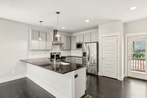 a kitchen with kitchen island a sink and refrigerator