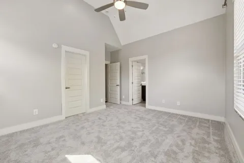a view of an empty room with a ceiling fan