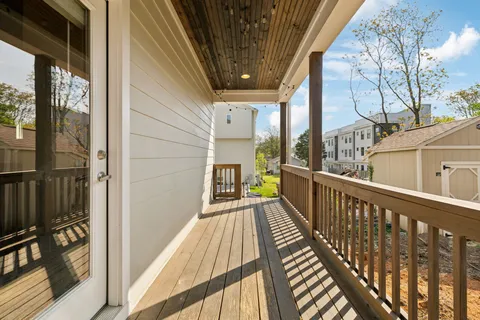 a view of balcony with wooden floor and fence