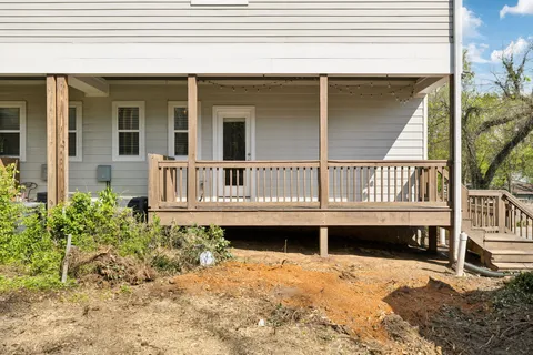 a view of a house with a wooden deck